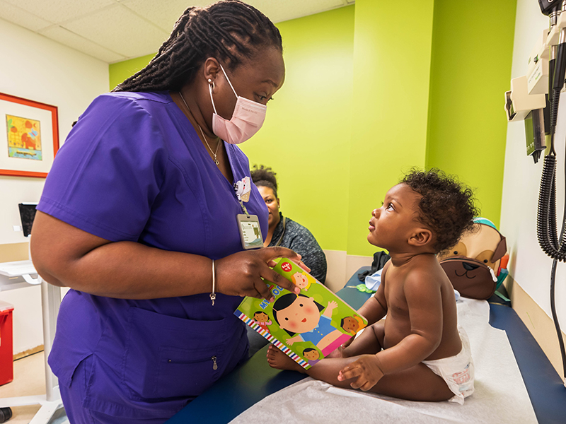 Children's of Mississippi patient Dallas Tucker of Jackson listens to his pediatrician, Dr. Kaisha Griffin, during a visit to the Batson Kids Clinic